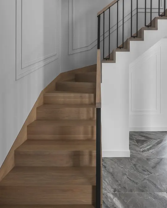 Turning staircase clad in bespoke oak treads and risers with matching oak skirting