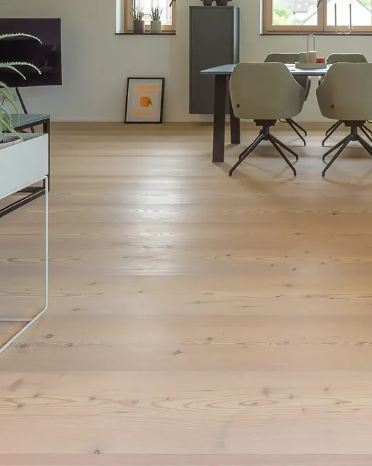 Wide plank larch wood flooring in a dining area