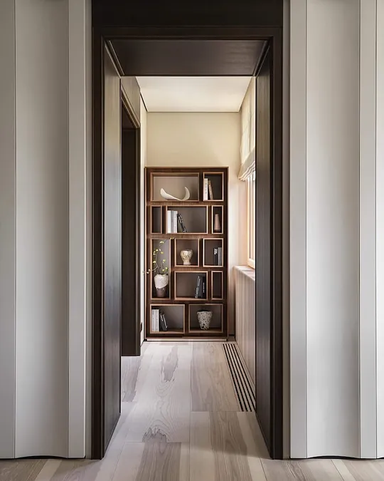 Wide plank ash wood flooring in a long hallway